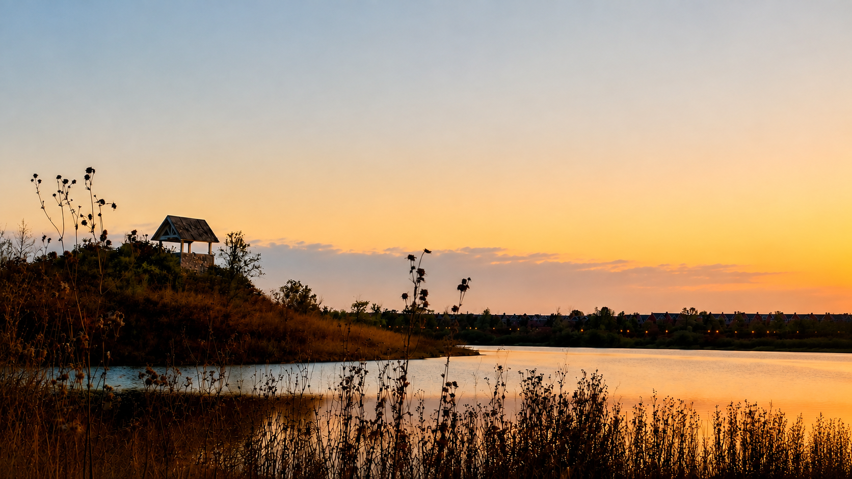 A pavilion beside a quiet lake beneath a crescent moon